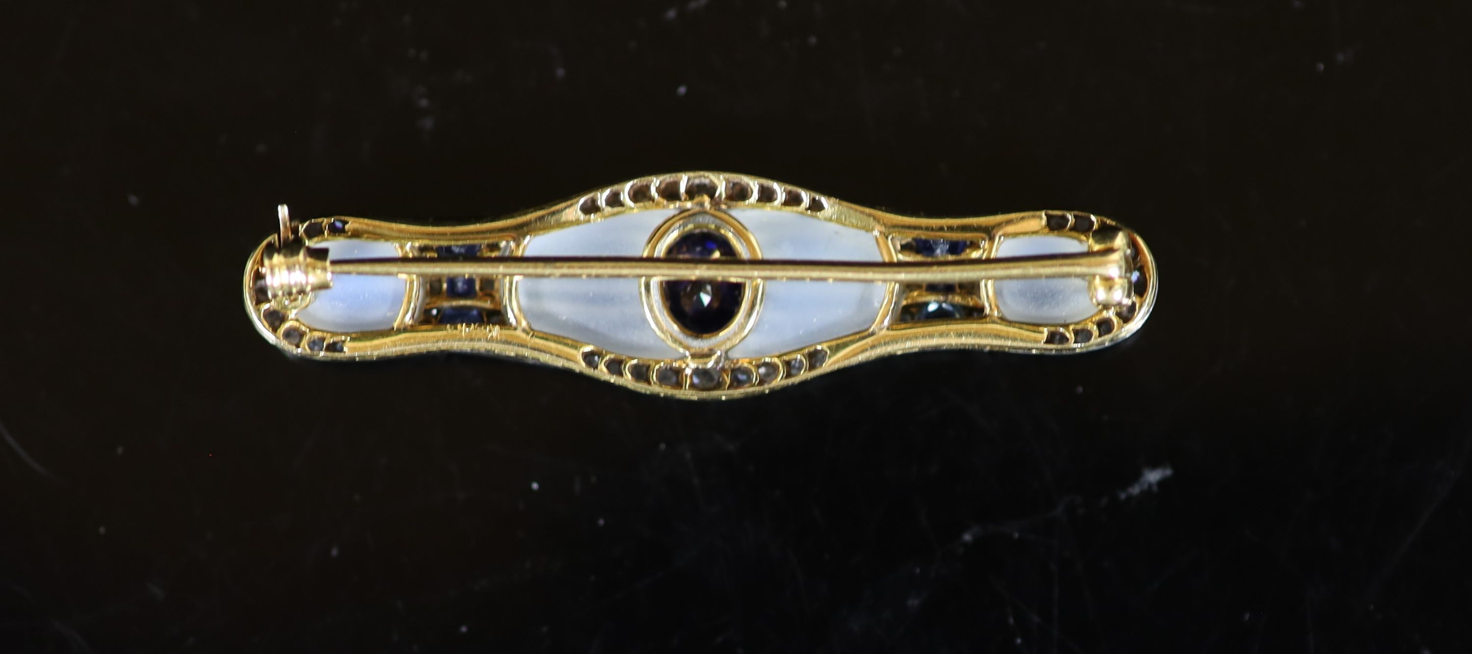 An early 20th century Austrian gold, platinum, millegrain set rose cut diamond and sapphire mounted fluted moonstone bar brooch, by (Konrad?) Koch